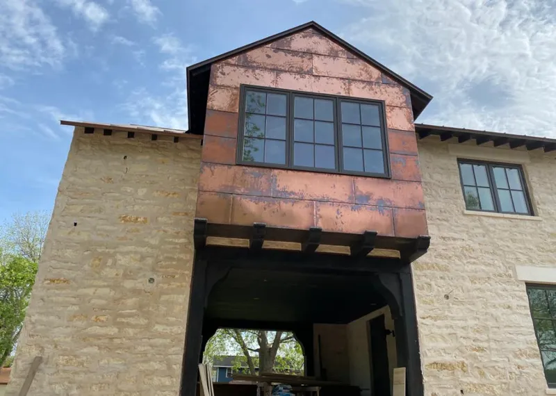 Copper metal panel facade on a stone building for Roof Repair in Clarkston Heights-Vineland